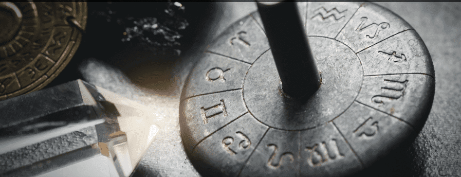 Horoscope zodiac wheel on a table.