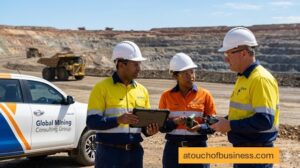 Mining consultants use tablets and drones to survey an active open-pit mine site.