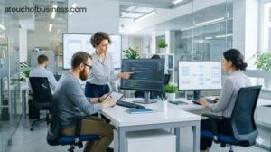 Team collaborating on wireframes and code in an app development company office.