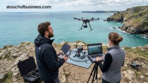 Drone photography business operating on a scenic coastline, two professionals flying a cinematic drone.