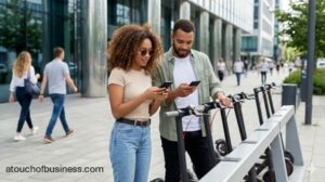 Couple unlocks electric scooters using a smartphone app at a city rental station.