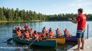 Kids canoeing on a lake at camp