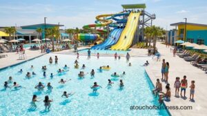 park wave pool in full operation on a sunny day with guests swimming.