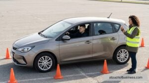A driving instructor signaling to student parallel parking a generic hatchback in a lot.