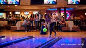 Diverse group celebrating a bowling throw under colorful LED lights in a modern entertainment center.