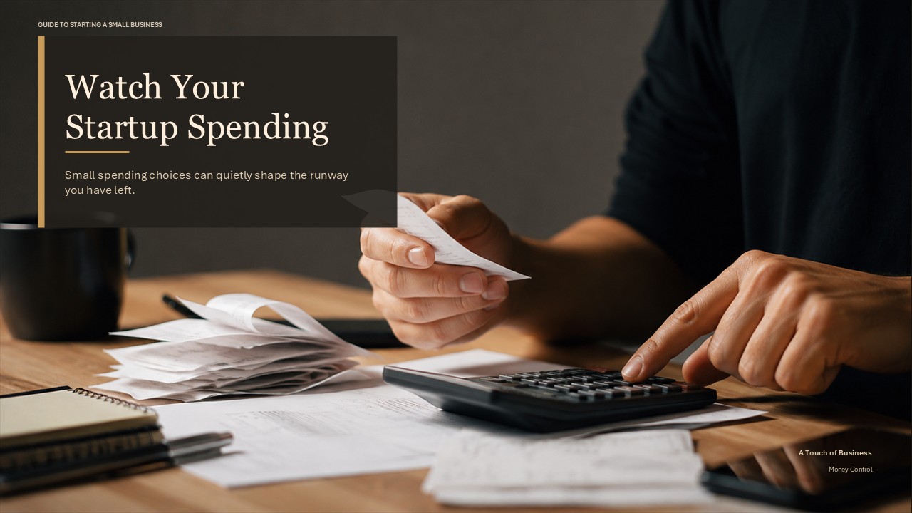 Hands reviewing receipts and using a calculator on a wooden business desk.