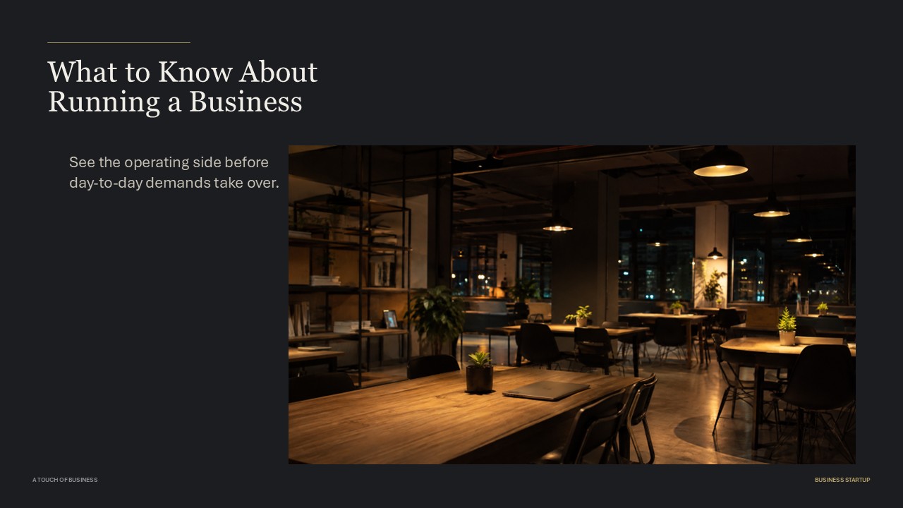 Warm, empty coworking space with tables, laptop, plants, and city lights.