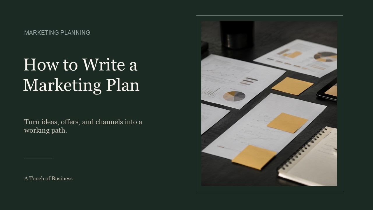 Marketing planning papers, charts, tablet, sticky notes, ruler, notebook, and pen on a dark desk.