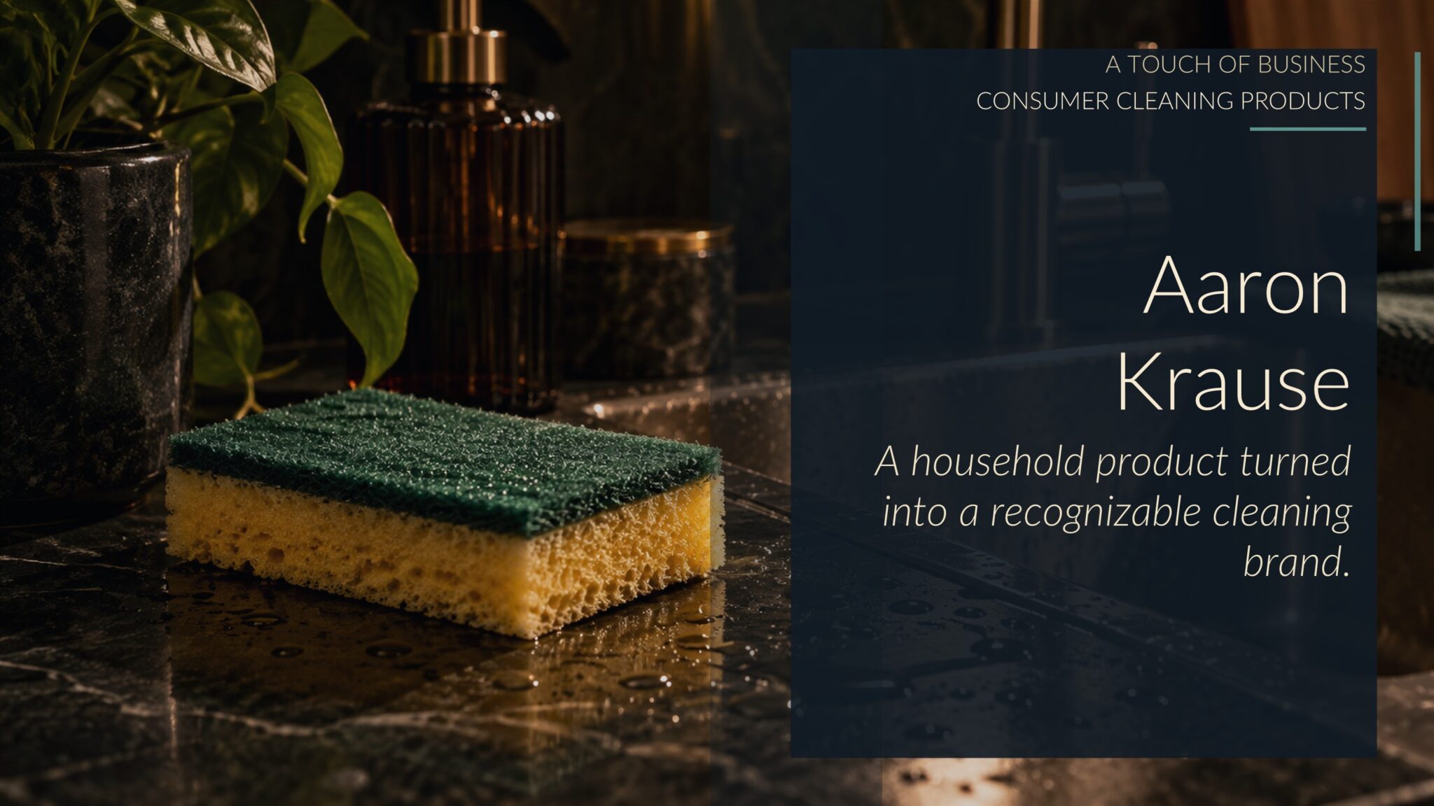 Cinematic kitchen sink still life with a scrub sponge, water droplets, brass faucet, and dark stone counter.