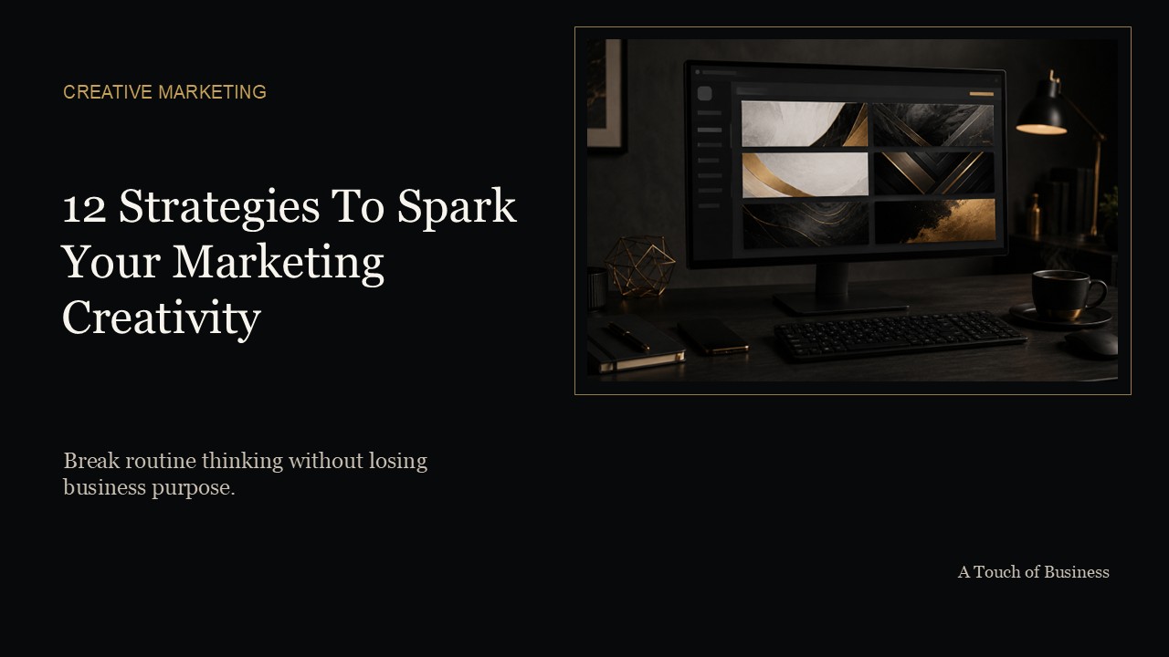 Dark creative workstation with monitor, abstract design panels, and warm desk lighting.