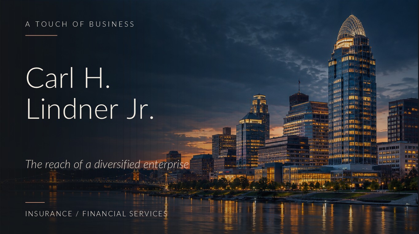 A glowing urban riverfront skyline and office towers at dusk beneath a dark blue sky.