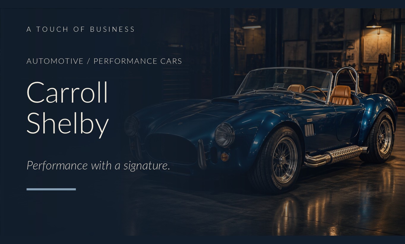 Midnight blue classic Cobra-style roadster in a dim amber-lit performance workshop.
