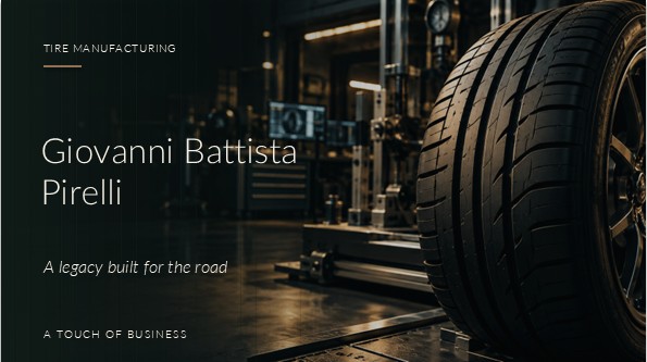 A close-up of a performance car tire mounted on a dark wheel in an amber-lit automotive testing workshop.
