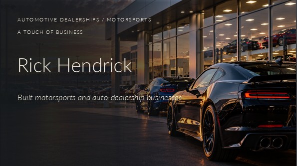 Photograph of unbranded performance cars outside a modern automotive dealership near a racetrack at sunset, with a black sports coupe in the foreground.